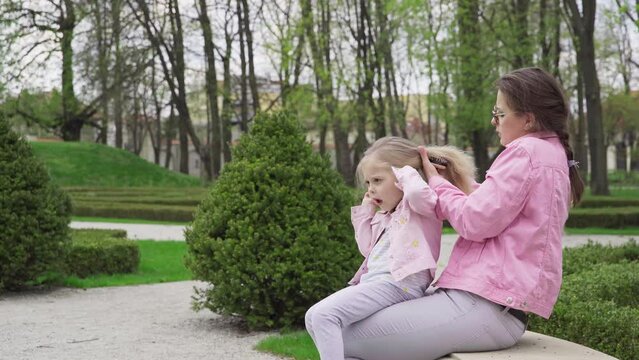 While combing her hair, Mom inadvertently pulled harder on it.