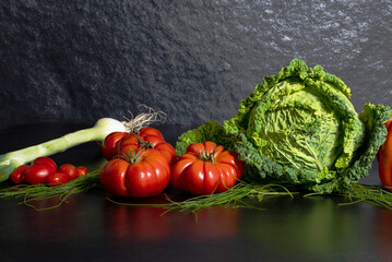 Fresh savoy cabbage, paprika, green onion, tomatoes on grey background. Top view detox concept, vegan, food cooking ingredients