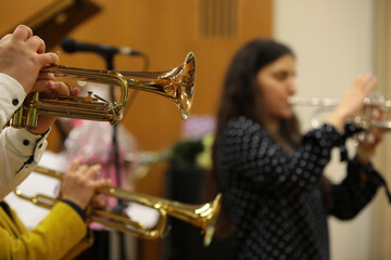 Orchestra of trumpeters playing a brass musical instrument golden trumpet close-up
