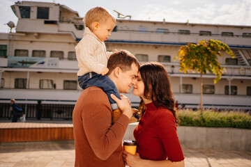 beautiful and happy family on the autumn embankment. 