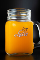 Orange lemonade glass with ice chips