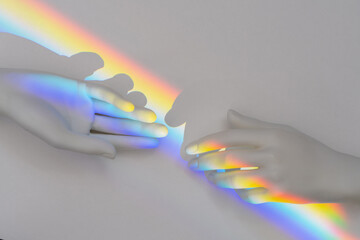 Top view of the rainbow prism reflection inside of the plastic hands