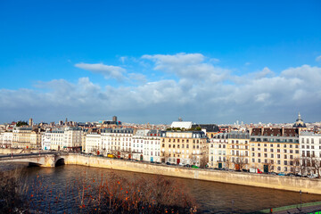 Fototapeta premium Paris residential houses situated at Seine river coast . Riverside buildings and bridge in Paris France 