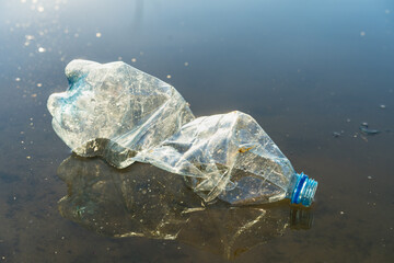 plastic garbage in a pond, the concept of cleaning the environment from the pollution of the planet