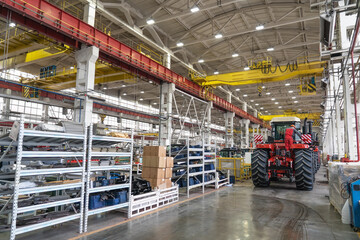 Large factory building interior inside. Production line of new modern agriculture machinery.