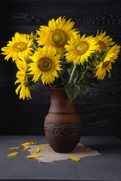 Still life with bouquet of sunflowers on a grey table