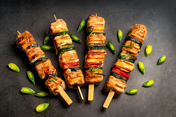 .Chicken shish kebab with zucchini. Top view.Grilled pieces of chicken meat on skewers.Grilled...