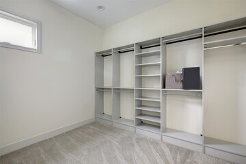 Empty walk-in closet with open shelves