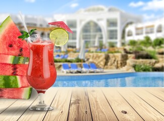 Tasty ripe fresh watermelon juice or smoothie in glasses with watermelon pieces. Refreshing summer drink