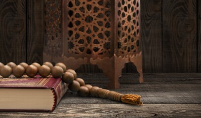 Fototapeta na wymiar The Holy Al Quran with written Arabic calligraphy on a desk