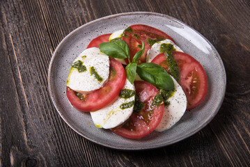 Caprese salad on wooden table