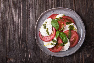 Caprese salad on wooden table. View from above
