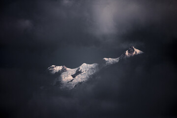 Naklejka na ściany i meble Mt. Kanchenjunga over the clouds