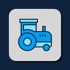 Filled outline Tractor icon isolated on blue background. Vector