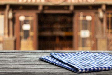 Empty wooden table and blurred background of abstract restaurant or coffee shop for display of product or for montage.