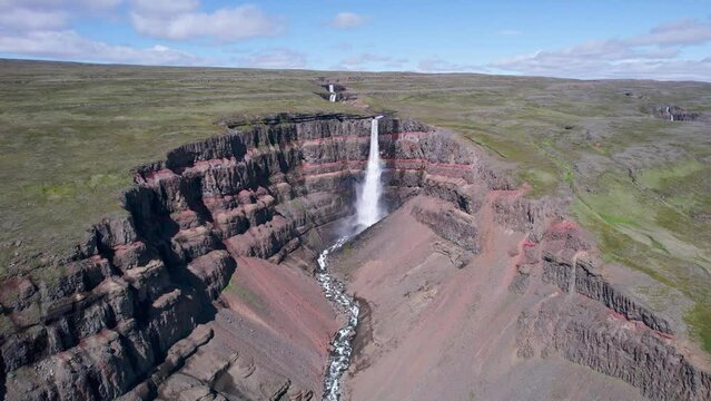 Hengifoss waterfall and surrounded by layers of basaltic strata and river flowing in Fljótsdalshreppur at East Iceland