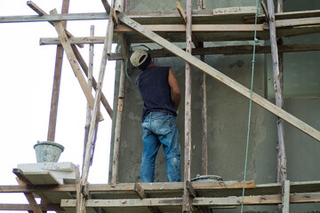 Naklejka na ściany i meble Workers are building on high, building house, worker, construction irons for building 