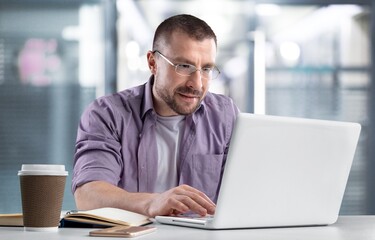 Portrait of sad bored business man sitting at desk, suffering job problems at office