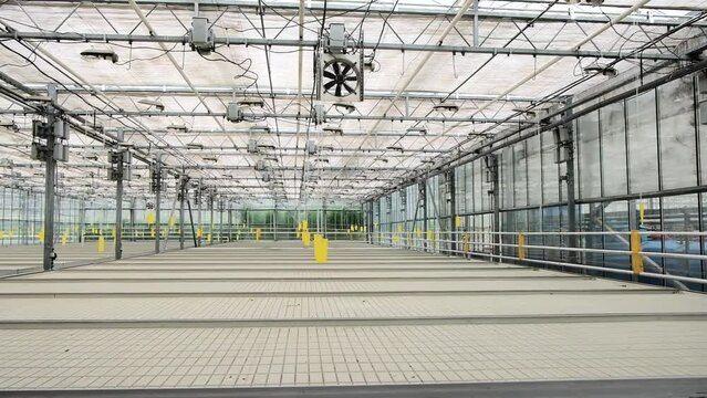 Empty greenhouse plantation. Food shortage. Concept for industrial agriculture. Famine and economic decline. Food crisis. Hunger. Large empty Greenhouse Building. 