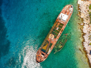 Aerial view over rusty shipwreck of an old cargo boat at Peristera island near Alonissos, Greece