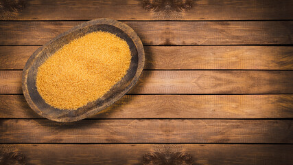 Organic brown sugar in the wooden bowl - Saccharum officinarum