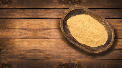 Maca powder in the wooden bowl - Lepidium meyenii.