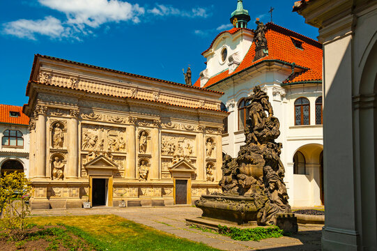 Courtyard of the Loreta monastery in Praha with beautiful baroque buildings and statues.