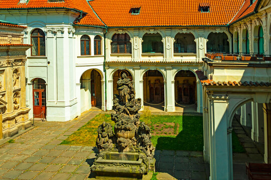 Courtyard of the Loreta monastery in Praha with beautiful baroque buildings and statues.