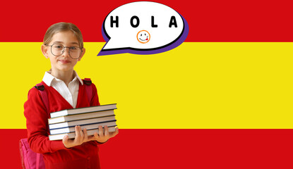 Little schoolgirl holding books and speech bubble with word HOLA (HELLO) against flag of Spain © Pixel-Shot