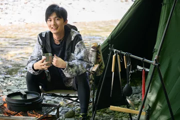 Foto op Canvas Men's solo camping for all seasons, looking at the camera © kapinon