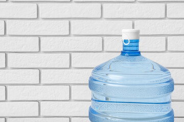 Bottle of clean water near light brick wall