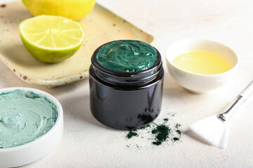 Jar of spirulina facial mask on light table
