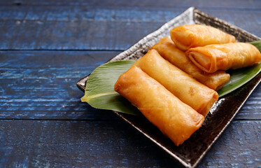 Multiple fried spring rolls on the table