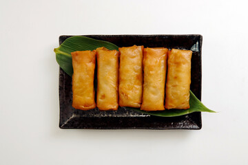 Multiple fried spring rolls on the table