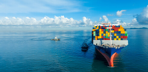 Front View contaier cargo ship import export container box on the ocean sea on blue sky back ground...