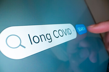 Close-up view of searching information on Long COVID on the internet - 517820340