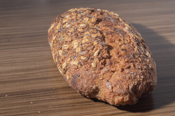 Whole wheat rye bread slice with seeds, multigrain bread on a wooden table with copy space