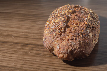 Whole wheat rye bread slice with seeds, multigrain bread on a wooden table with copy space