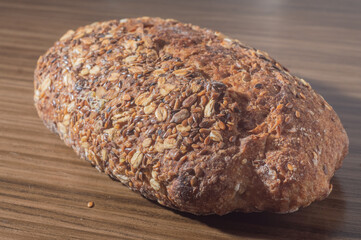 Whole wheat rye bread slice with seeds, multigrain bread on a wooden table with copy space