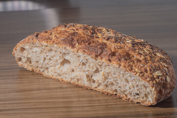 Whole wheat rye bread slice with seeds, multigrain bread on a wooden table with copy space