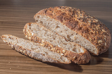 Whole wheat rye bread slice with seeds, multigrain bread on a wooden table with copy space