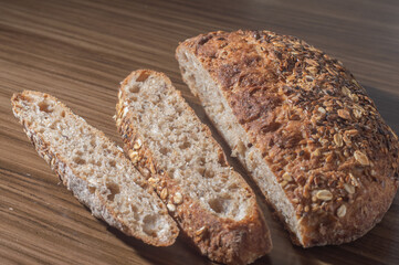 Whole wheat rye bread slice with seeds, multigrain bread on a wooden table with copy space