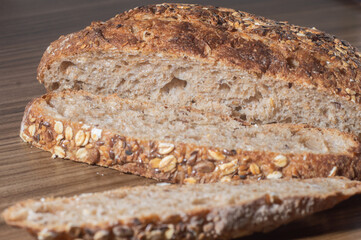 Whole wheat rye bread slice with seeds, multigrain bread on a wooden table with copy space