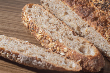 Whole wheat rye bread slice with seeds, multigrain bread on a wooden table with copy space