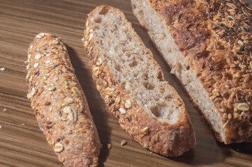 Whole wheat rye bread slice with seeds, multigrain bread on a wooden table with copy space