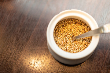 sesame seeds and a wooden dark table. Copy space.
