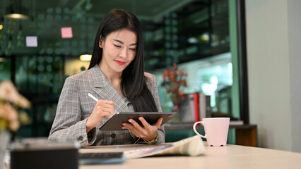 Businesswoman using her portable digital tablet.