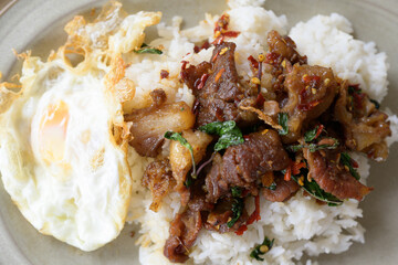 Stir fried basil with beef and fried egg for lunch menu.Traditional Thai street food.Spicy taste menu