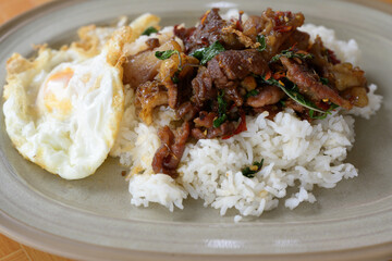 Stir fried basil with beef and fried egg for lunch menu.Traditional Thai street food.Spicy taste menu