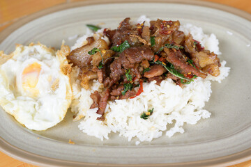 Stir fried basil with beef and fried egg for lunch menu.Traditional Thai street food.Spicy taste menu